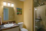 The second bathroom has a glass walk-in shower